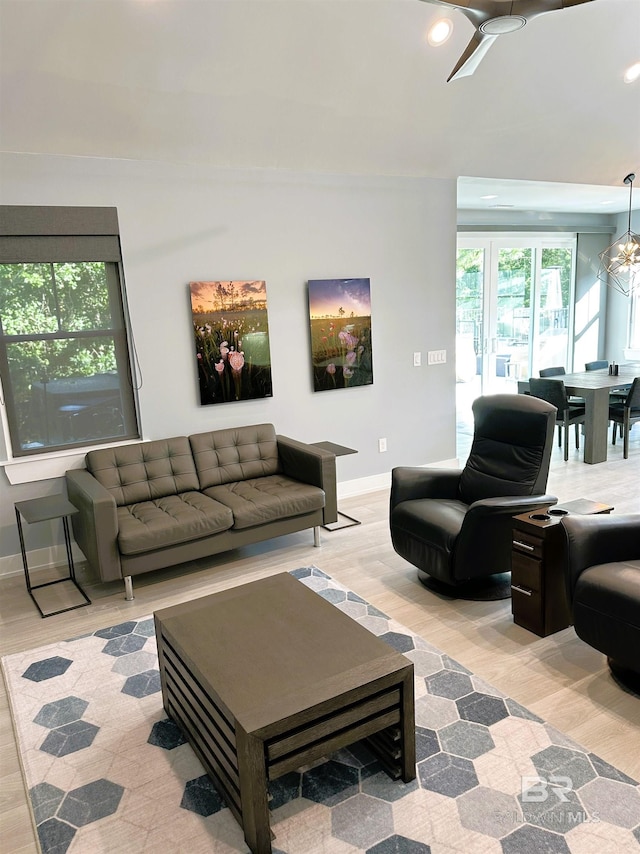 living room with a chandelier and light hardwood / wood-style flooring