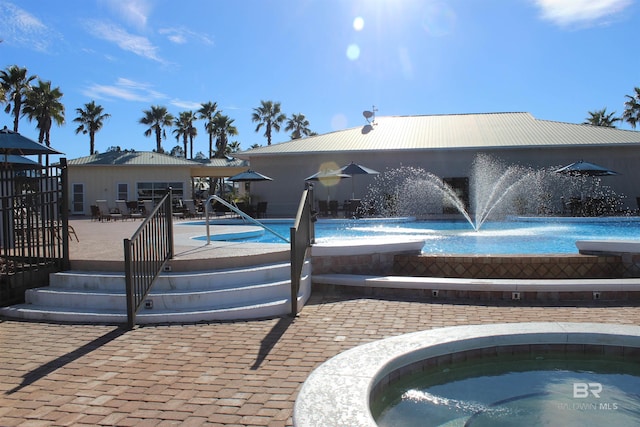 view of pool with pool water feature