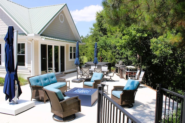 view of patio featuring an outdoor living space with a fire pit