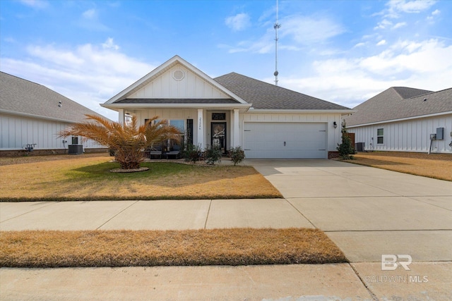 ranch-style house with a garage, central AC, and a front yard