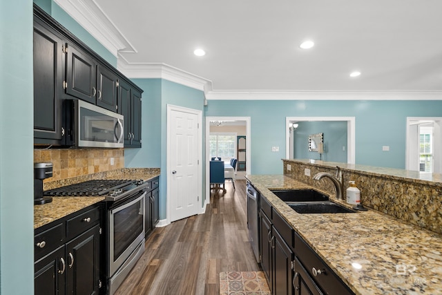 19083 County Road 13, Fairhope, AL 36532 - kitchen with appliances with stainless steel finishes, a sink, dark cabinets, crown molding, and plenty of natural light