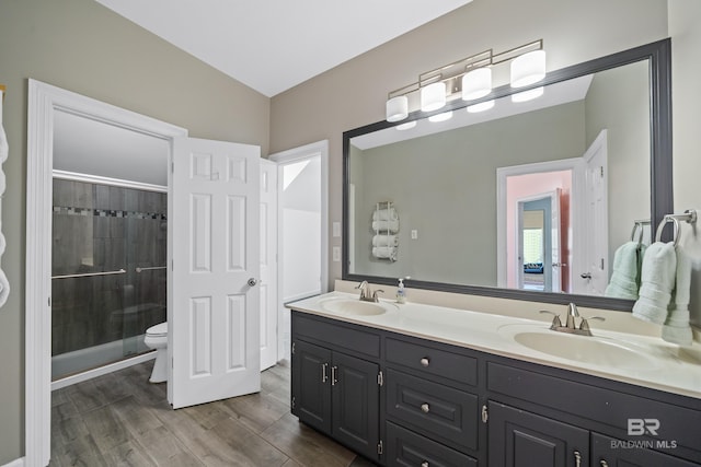19083 County Road 13, Fairhope, AL 36532 - full bath featuring a stall shower, double vanity, wood finished floors, and toilet