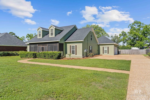19083 County Road 13, Fairhope, AL 36532 - cape cod house featuring concrete driveway, a sunroom, and roof with shingles