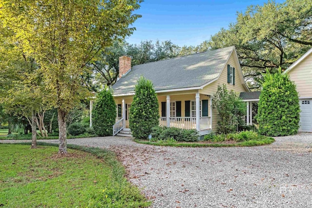 cape cod-style house with covered porch and a garage