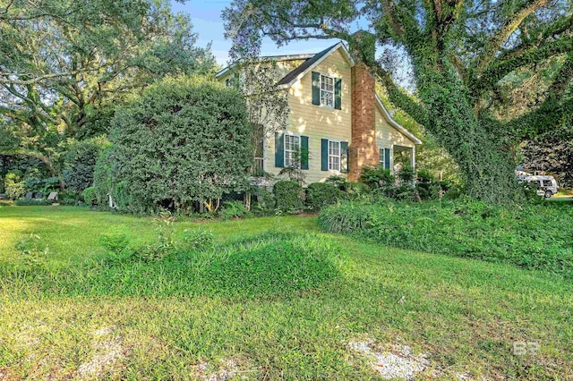 view of home's exterior with a yard