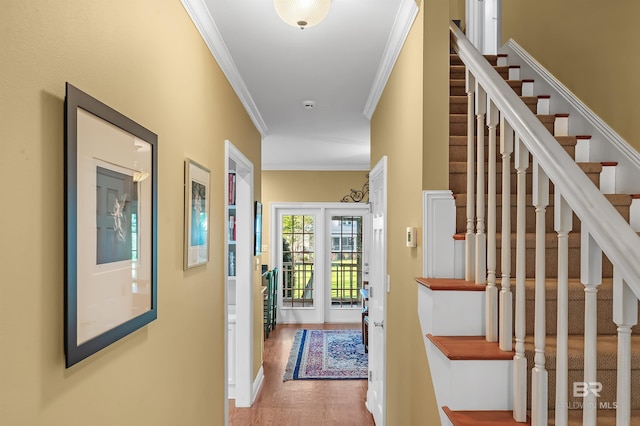 hallway featuring ornamental molding and hardwood / wood-style flooring