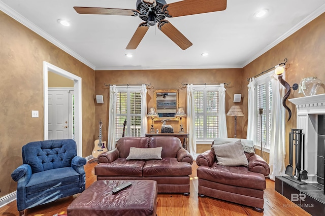 living room with ceiling fan, crown molding, plenty of natural light, and hardwood / wood-style floors