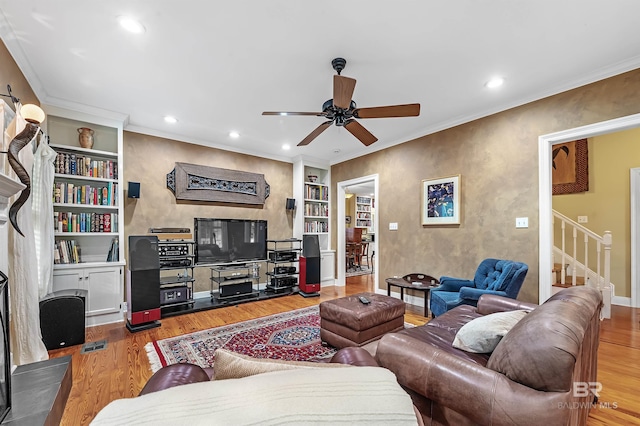 living room featuring ceiling fan, hardwood / wood-style flooring, and crown molding