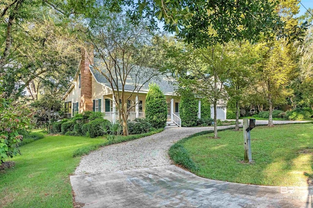 view of front facade with a front yard and covered porch