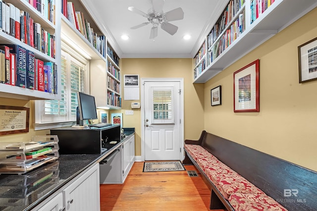 interior space featuring light hardwood / wood-style floors, crown molding, and ceiling fan