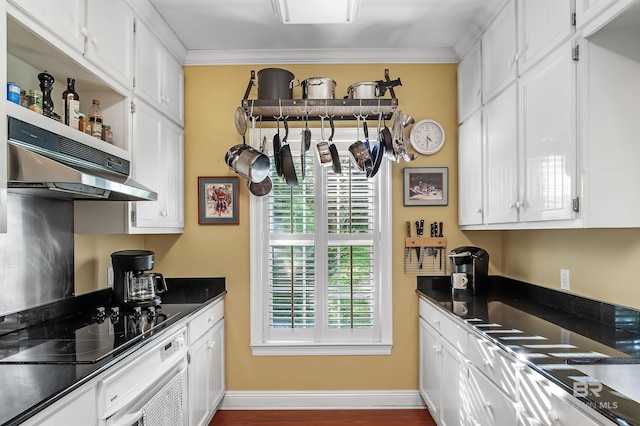 kitchen featuring black electric cooktop, white cabinets, and ornamental molding