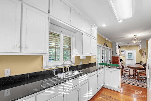 kitchen with light wood-type flooring, sink, crown molding, white cabinetry, and dishwasher