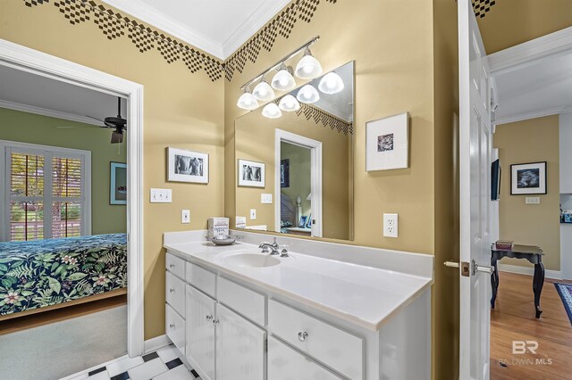 bathroom featuring ornamental molding, ceiling fan, and vanity