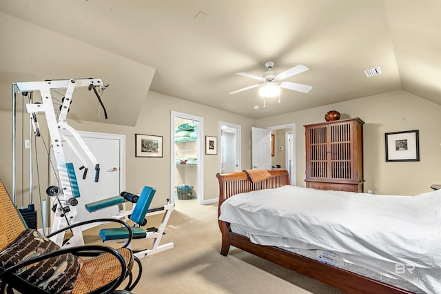 bedroom featuring ceiling fan, light carpet, lofted ceiling, and a closet