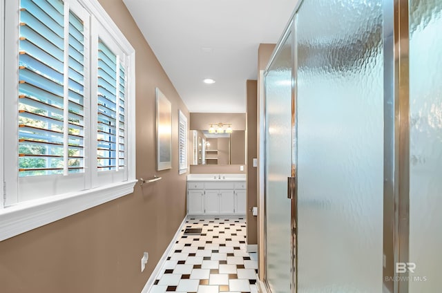 bathroom featuring an enclosed shower and vanity