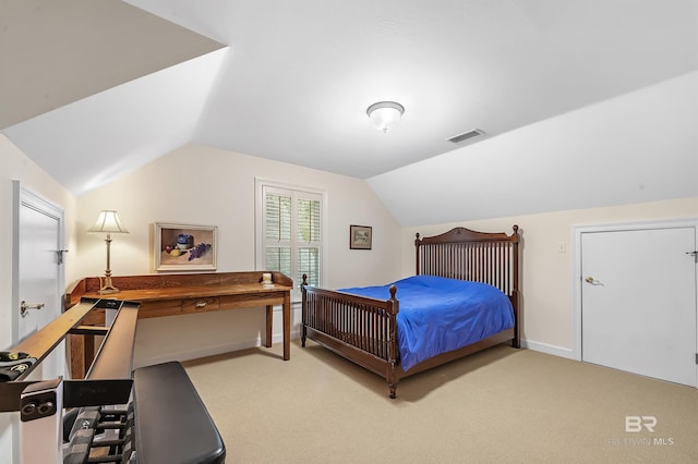 carpeted bedroom with vaulted ceiling