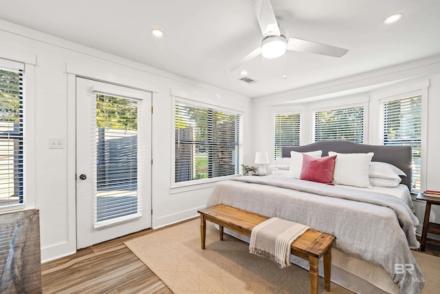 bedroom featuring access to exterior, ceiling fan, and wood-type flooring