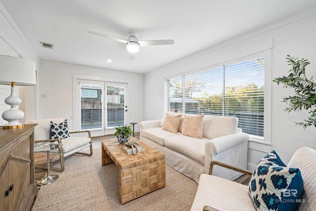 living room featuring ceiling fan and ornamental molding