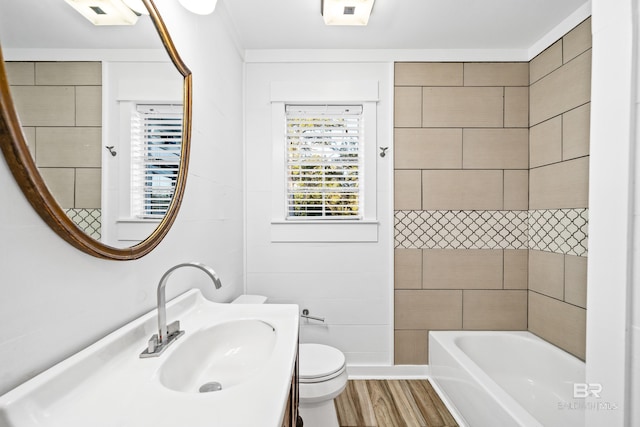 full bathroom featuring shower / bathing tub combination, toilet, wood-type flooring, and sink