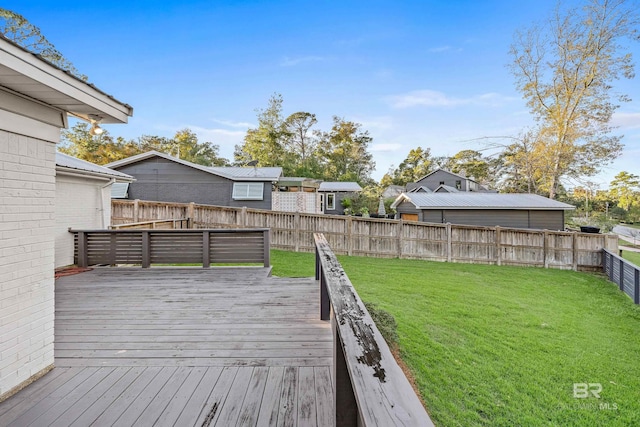 wooden terrace featuring a lawn