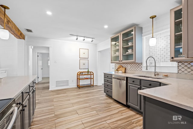 kitchen with tasteful backsplash, gray cabinetry, sink, decorative light fixtures, and dishwasher