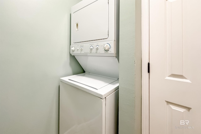 laundry area featuring stacked washer / dryer