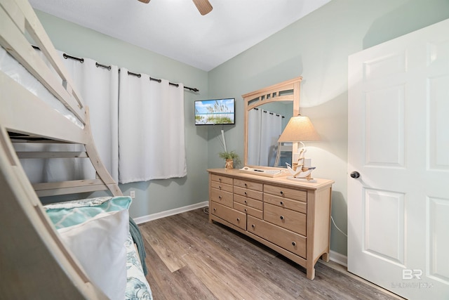 bedroom with ceiling fan and hardwood / wood-style flooring