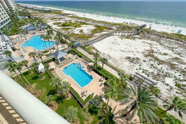 drone / aerial view with a water view and a beach view