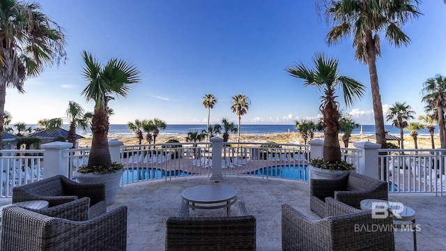 view of pool featuring a water view and a patio area