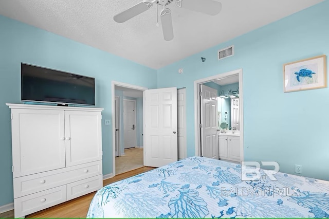 527 Beach Club Trl Unit D710, Gulf Shores, AL 36542 - bedroom with light wood finished floors, ensuite bathroom, ceiling fan, and a sink