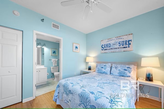 527 Beach Club Trl Unit D710, Gulf Shores, AL 36542 - bedroom with wood finished floors, ensuite bath, a ceiling fan, and baseboards