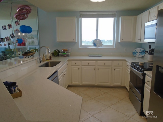527 Beach Club Trl Unit D710, Gulf Shores, AL 36542 - kitchen featuring a sink, appliances with stainless steel finishes, light tile patterned floors, and white cabinets