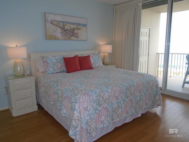527 Beach Club Trl Unit D710, Gulf Shores, AL 36542 - bedroom with wood finished floors and access to exterior