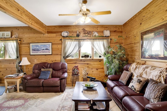 living room featuring ceiling fan and wood walls