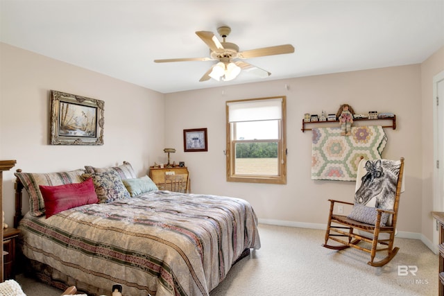 bedroom with light colored carpet, baseboards, and a ceiling fan