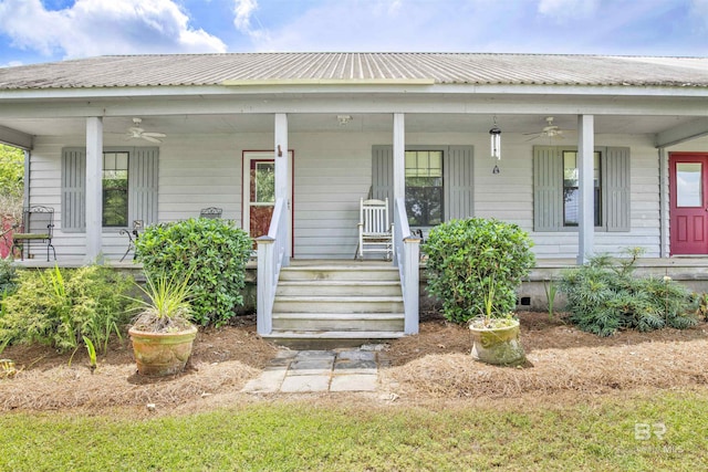 entrance to property featuring a ceiling fan, covered porch, and metal roof