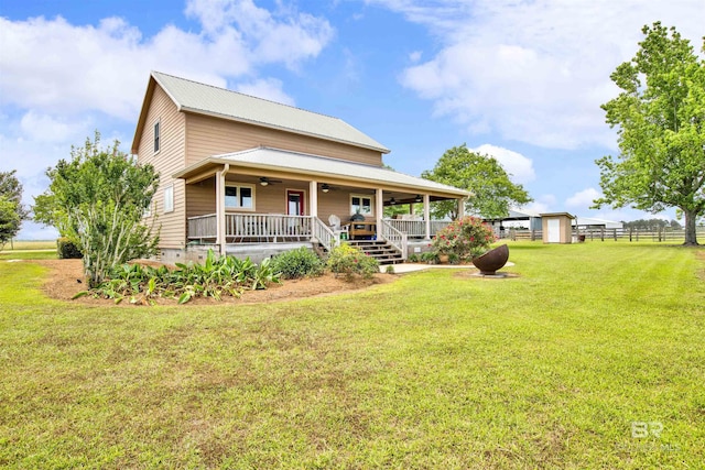 view of front of house with ceiling fan, covered porch, and metal roof
