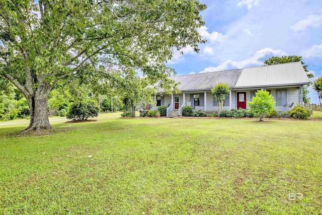 ranch-style house with covered porch, a front yard, and metal roof