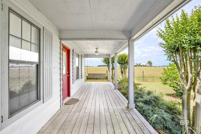 wooden deck with a ceiling fan and a view of countryside