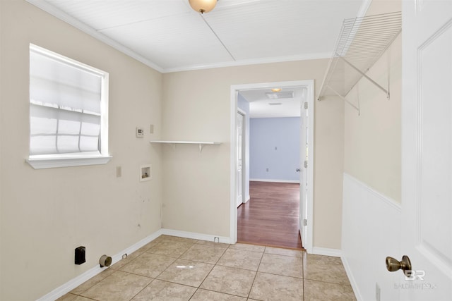 laundry area featuring washer hookup, light tile patterned flooring, baseboards, and crown molding