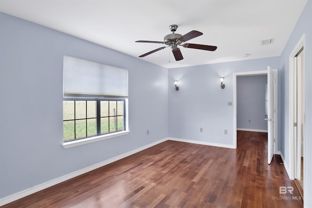 spare room with ceiling fan, baseboards, and wood finished floors