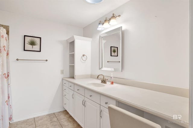 full bath featuring vanity, tile patterned flooring, and baseboards