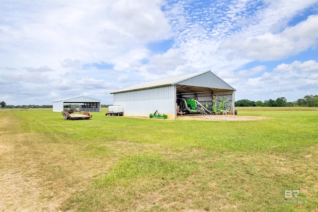 view of grassy yard with an outbuilding and a detached carport