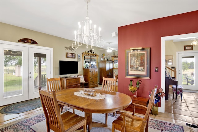 dining room with french doors, plenty of natural light, a chandelier, and stairs