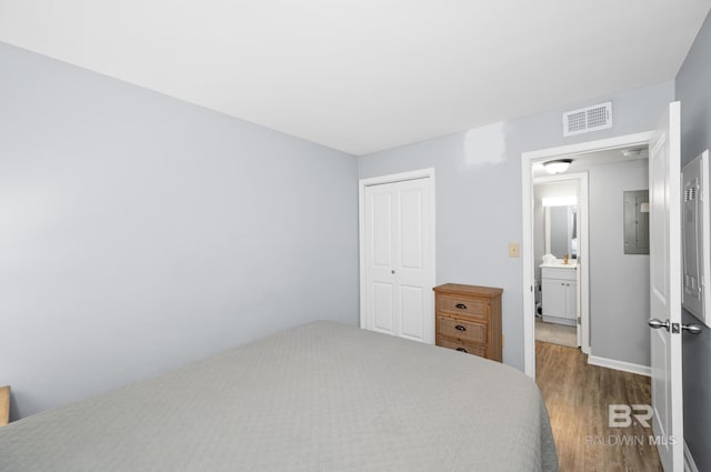 bedroom featuring wood-type flooring and a closet