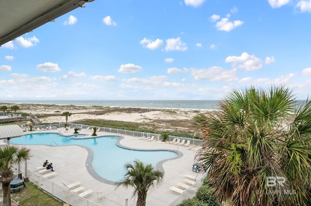 view of pool with a patio and a water view