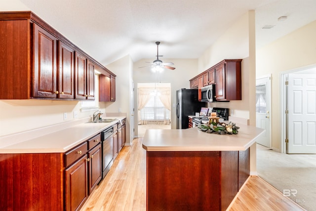 kitchen with light hardwood / wood-style floors, lofted ceiling, kitchen peninsula, black appliances, and ceiling fan