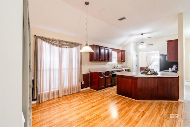 kitchen with ceiling fan, hanging light fixtures, refrigerator, light wood-type flooring, and vaulted ceiling