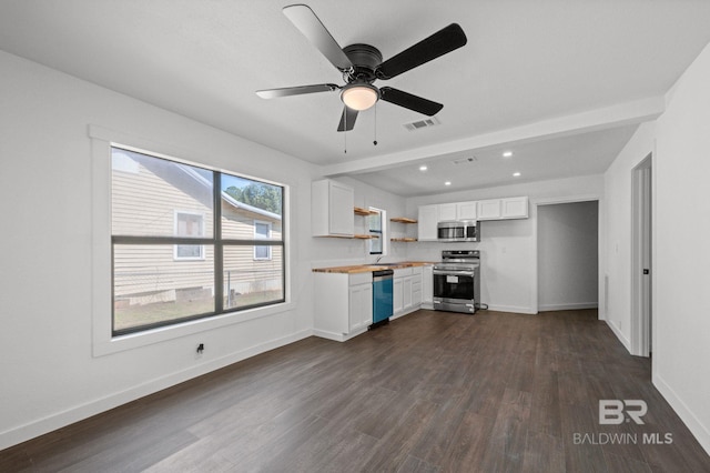 kitchen with ceiling fan, sink, stainless steel appliances, dark hardwood / wood-style floors, and white cabinetry