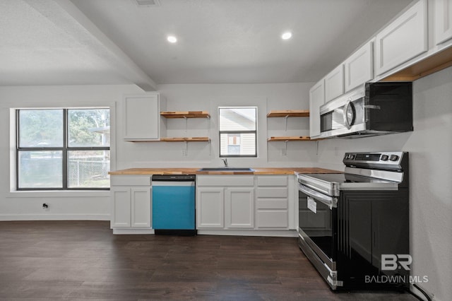 kitchen with stainless steel appliances, sink, dark hardwood / wood-style flooring, and white cabinetry